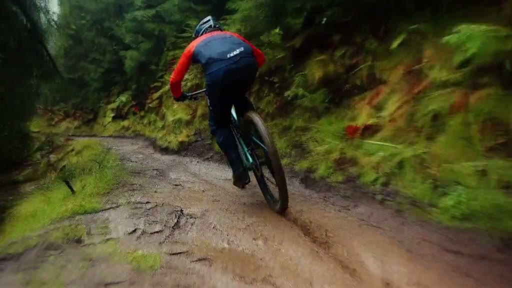 MiniMax H3 output: a mountain biker tracking shot on a wet forest trail