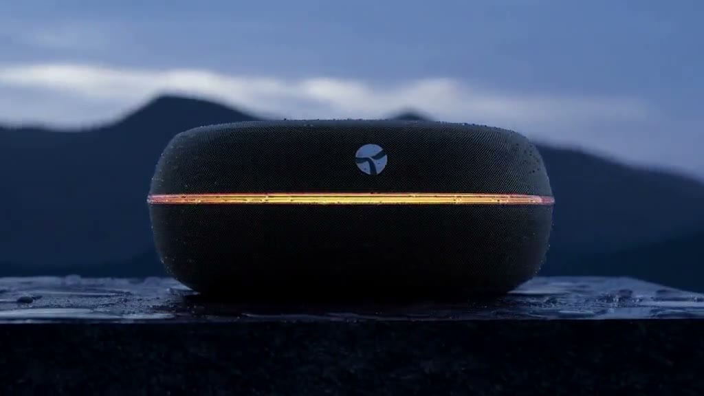 MiniMax H3 output: a matte-black wireless speaker on a wet stone plinth in the rain