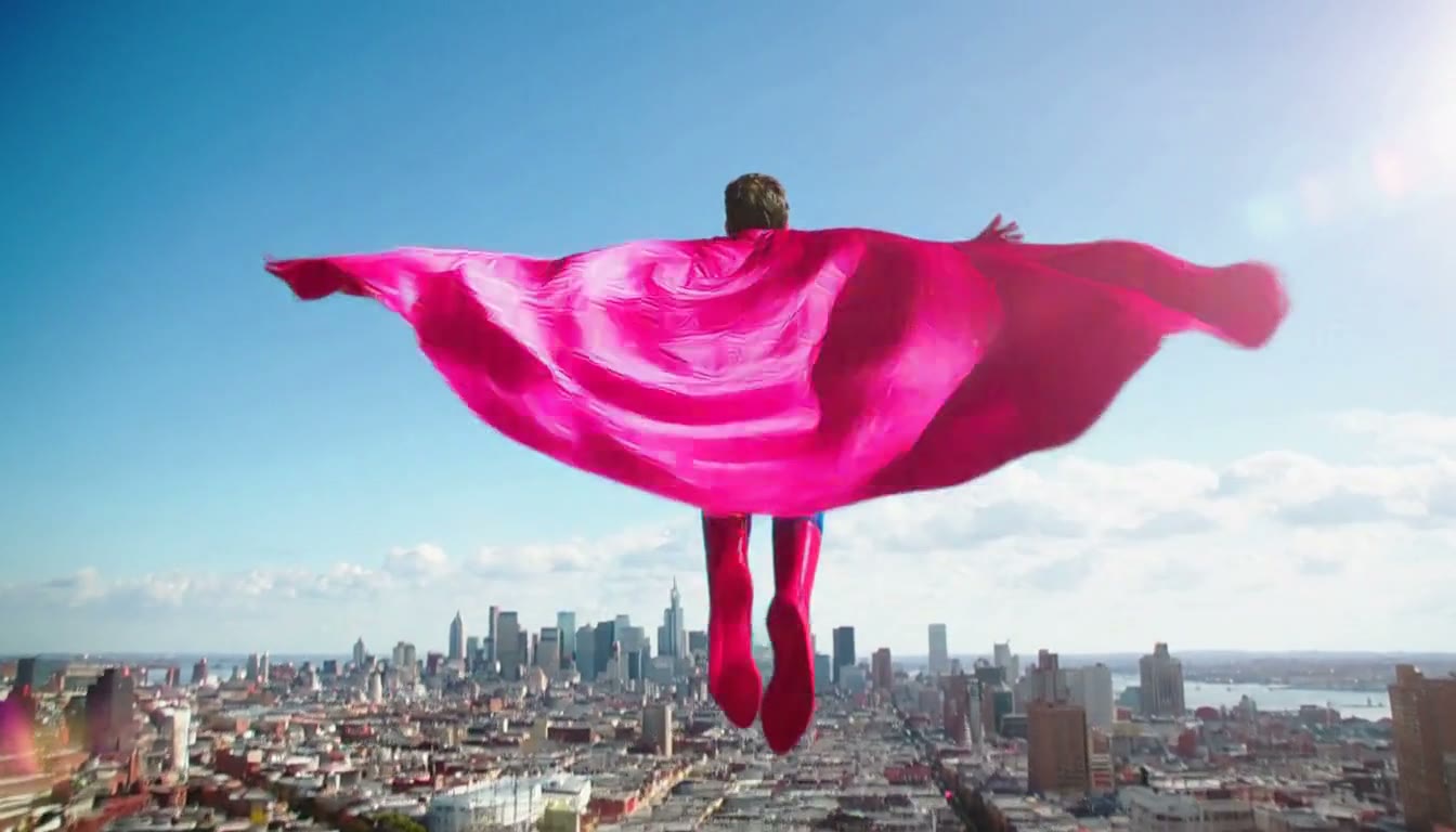 MiniMax H3 AI video example showing a man in a vibrant superhero costume takes flight over a cityscape
